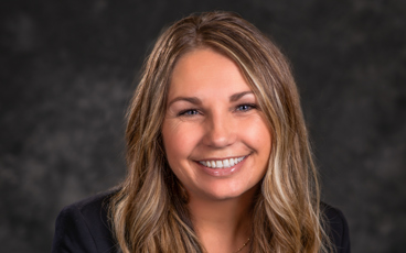 Headshot of Melissa McQueen wearing a blac blazer and white blouse.