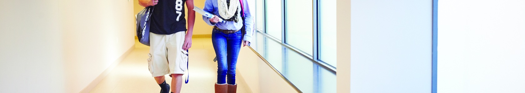 Students walking instructional building hallway