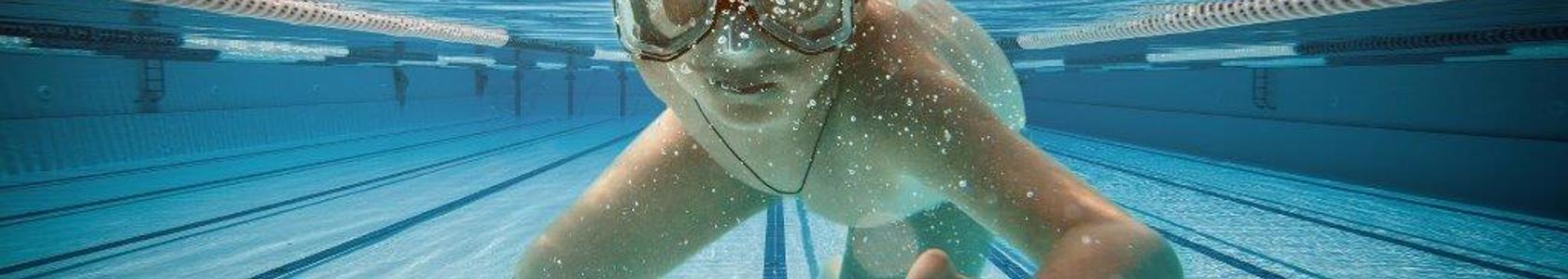 Child swimming underwater in pool