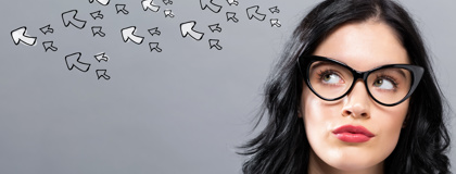 Woman wearing glasses looks at arrows above head