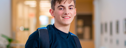 Male college student with dark blue shirt