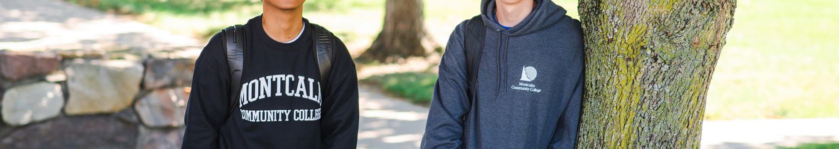 two students standing outside on campus.