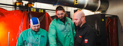 Two MCC Welding students working with MCC Welding Instructor, Drew Nielsen.