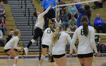 Volleyball player, Erin Borek, goes up for spike