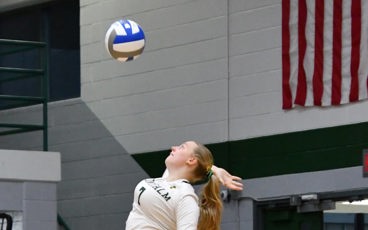 MCC Volleyball player serving the ball during a match.