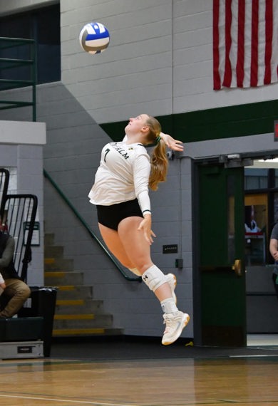 MCC Volleyball player serving the ball during a match.