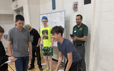 Dr. Alex Montoye working with a group of students at a local high school on Exercise Science activities. 