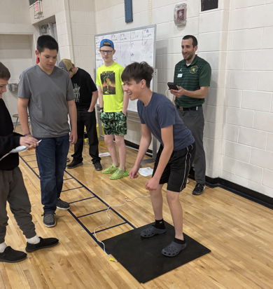 Dr. Alex Montoye working with a group of students at a local high school on Exercise Science activities. 