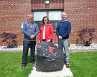 From left, St. Louis High School Principal Ben Brock, MCC English Instructor Erin Busch-Grabmeyer and MCC Dual Enrollment English Instructor/Coordinator Ben Stancil pose for a photo behind the rock outside the entrance of St. Louis High School. 