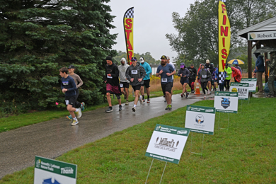 Participants running in 11th annual Bramble Ramble amidst rainy conditions. 