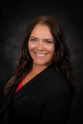 Professional photo of Angie Williams weraing a black blazer and red shirt smiling at the camera.