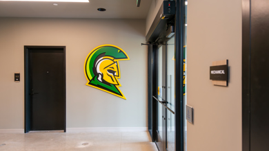 Inside the front entrance of Carbonelli Villas showing the front doors, a Centurion logo cutout on the all and one of the villa entrances.