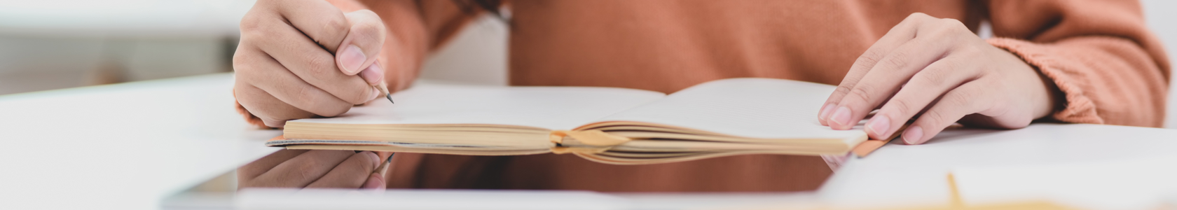 Woman Writing On Notebook