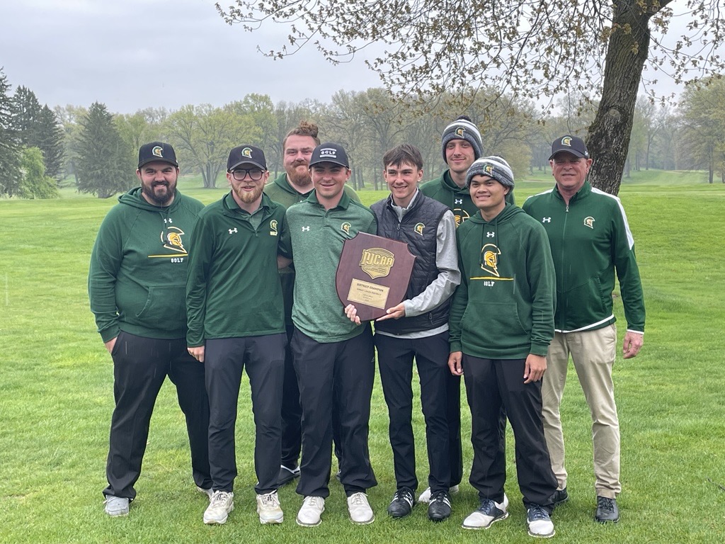 Photo of the 2025 men's golf team standing outside holding their Regional Championship plaque.