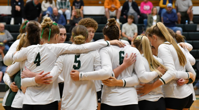 MCC volleyball team huddled