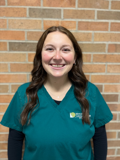 Headshot of Reygan Holt wearing a green MCC Nursing scrub top with a black long sleeve underneath and a silver necklace.