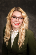 Headshot of Marleigh Worden wearing a cream button down shirt with an army green jacket on top.