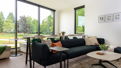 Styled living room in Carbonelli Villas featuring a couch and dining area.