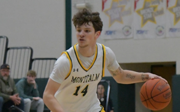 MCC men's basketball player Trevor Zammaron dribbling the ball on the court. 