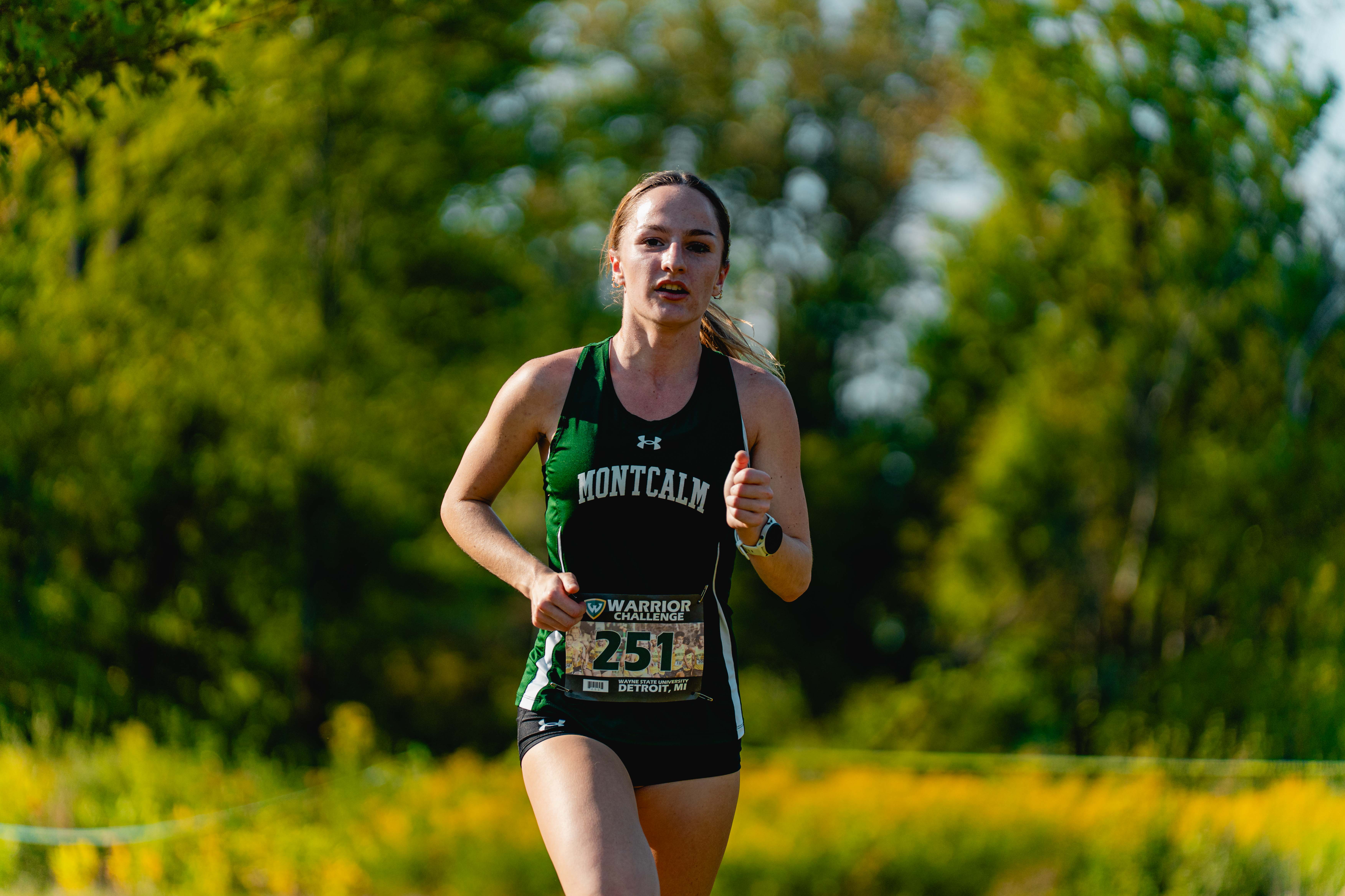 MCC women's cross country runner Abby Davis running on a course.