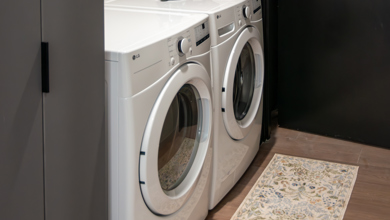 Carbonelli Villas laundry room in one of the ground level suites featuring a full size washer and dryer and additional storage cabinets.