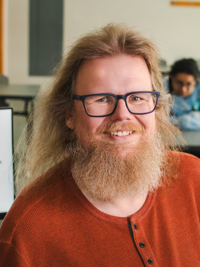 MCC Counselor and Faculty Tore Skogseth smiling in front of a classroom.