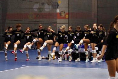MCC Women's Volleyball team having fun on the court before a match.