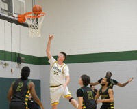 MCC Basketball player, Gabe Daniel, shooting a layup during a game.